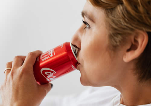 Woman drinking sugary soda