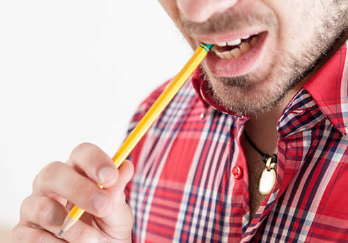 Man biting his pencil